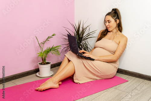 Pregnant Woman Relaxed at Home with Laptop