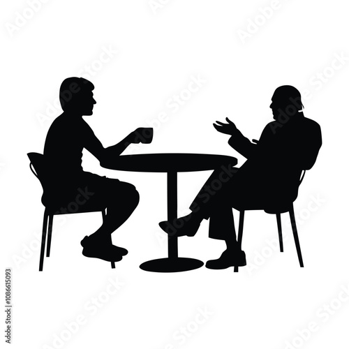 Two men sitting at a table. One man is drinking coffee. The other man is talking. There are two chairs