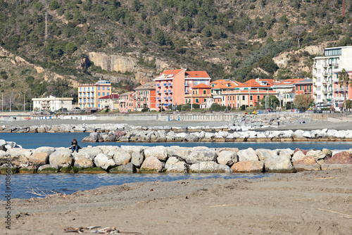 Breakwater on Mediterranean beach. Nature of sea and mountains. Setri Levante, Liguria.  photo