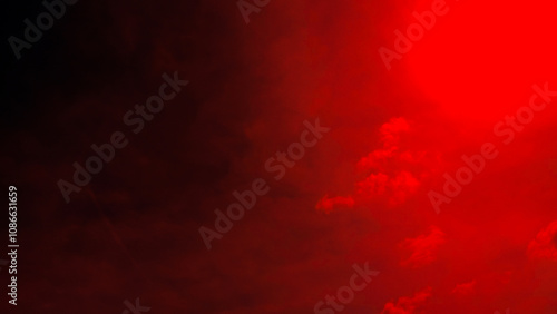 Background is a dark red sky with wide horizontal clouds.