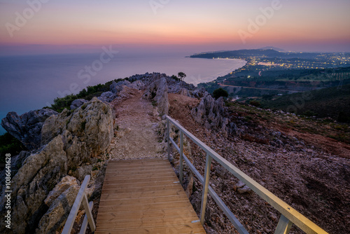 Sunrise over the island of Zakhyntos from a vantage point on the rocks photo