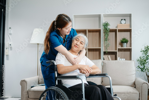 Asian caregiver doctor examine older patient woman therapist nurse at nursing home taking care of senior elderly woman sit on sofa.Medical service concept. photo