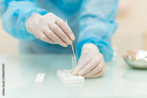 Lab test by medical professional. A medical worker in gloves carefully performs a diagnostic test in a clean laboratory environment. photo