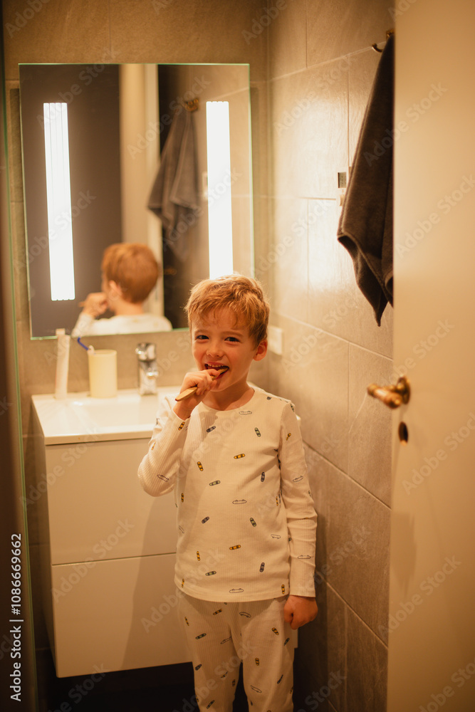 Young boy brushing his teeth independently in a bathroom, practicing good dental hygiene. Ideal for concepts of health, self-care, and children's daily routines. Young boy brushing his teeth independently in a bathroom, practicing good dental hygiene. Ideal for concepts of health, self-care, and children's daily routines.