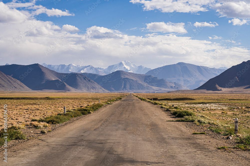 Scenic mountain landscape view of Pamir Highway aka M41 near Karakul, with snowcapped Muzkol range, Murghab, Gorno-Badakhshan, Tajikistan Scenic mountain landscape view of Pamir Highway aka M41 near Karakul, with snowcapped Muzkol range, Murghab, Gorno-Badakhshan, Tajikistan