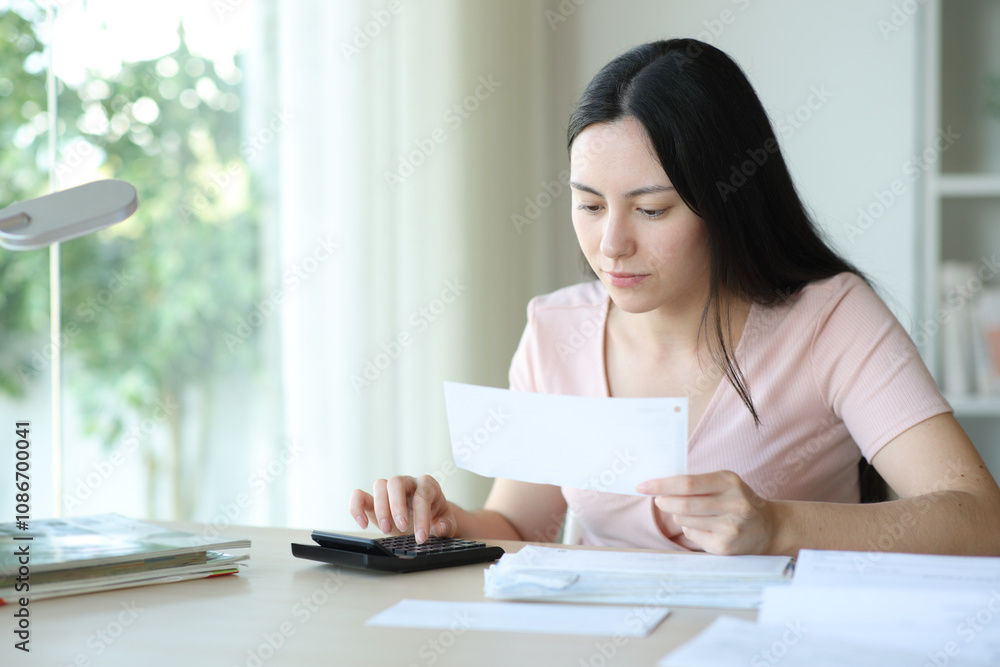 Asian woman calculating expenses checking bill Asian woman calculating expenses checking bill