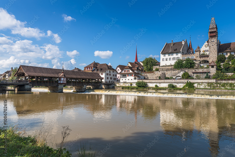 Obraz premium Reuss River with historic wooden bridge and Muri-Amthof, Bremgarten, Canton of Aargau, Switzerland