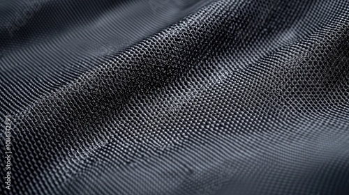 Close-up of textured black fabric showcasing waves and depth, highlighting its intricate patterns and material.