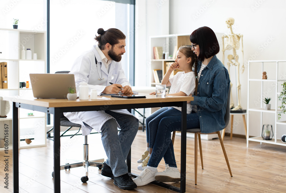 Caucasian doctor examines young girl who is coughing in clinic. Doctor is writing prescription while mother holds girl on lap. Scene depicts healthcare and care in medical setting. Caucasian doctor examines young girl who is coughing in clinic. Doctor is writing prescription while mother holds girl on lap. Scene depicts healthcare and care in medical setting.