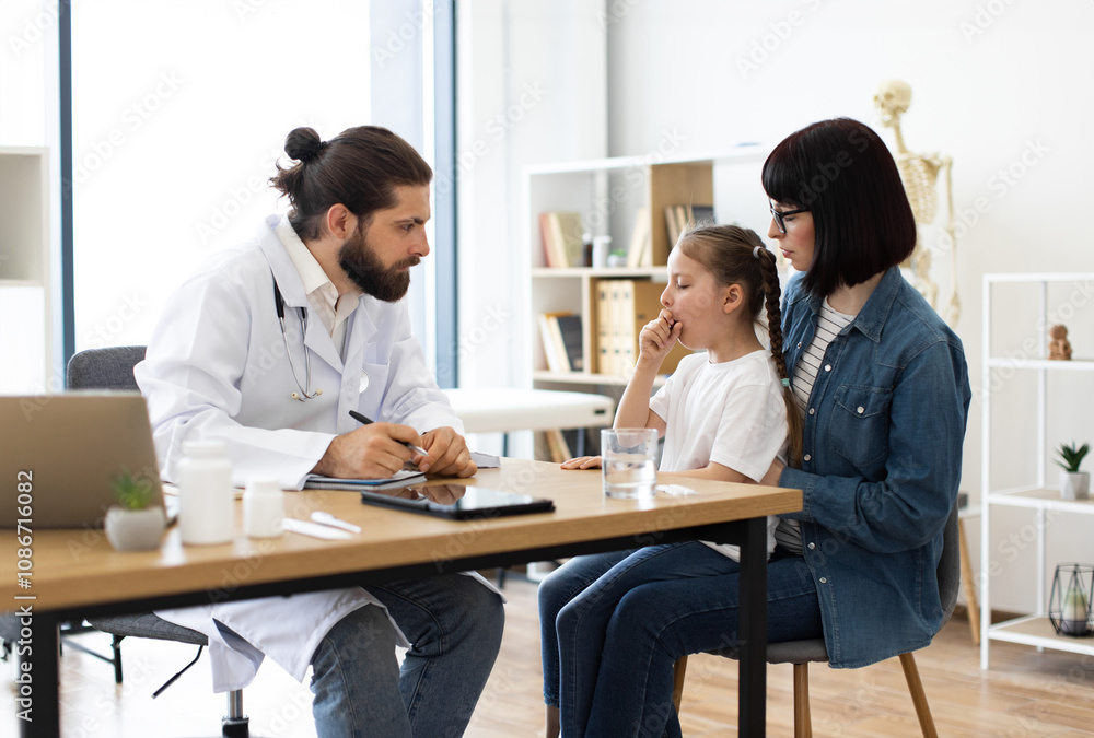 Caucasian male doctor examines young Caucasian girl coughing while mother listens in clinic. Doctor writes prescription as part of medical care. Caucasian male doctor examines young Caucasian girl coughing while mother listens in clinic. Doctor writes prescription as part of medical care.
