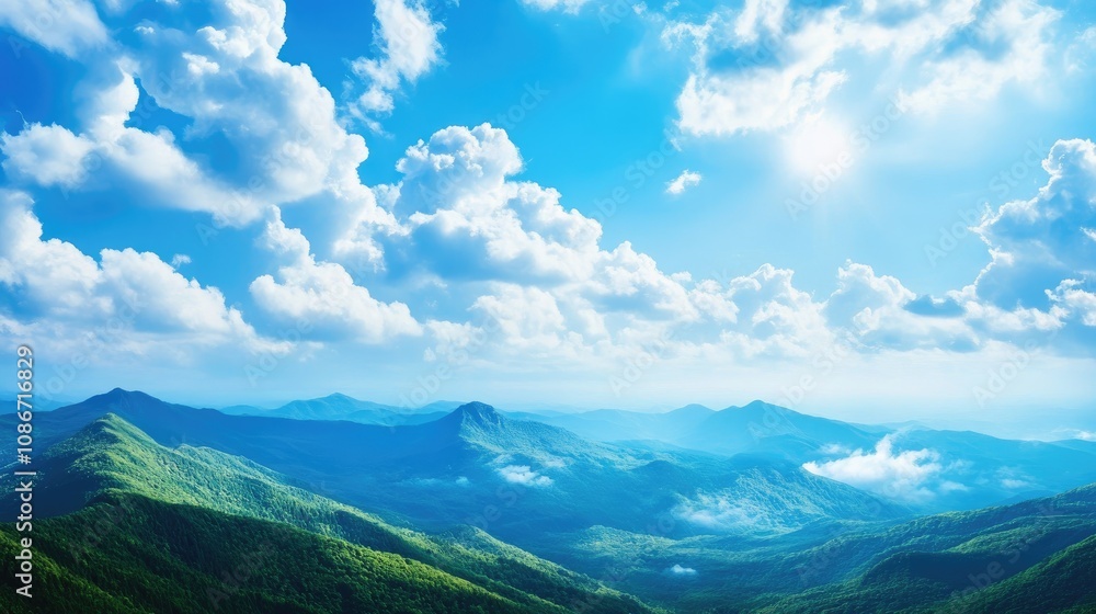 Breathtaking panoramic view of lush green mountains under a vibrant blue sky with fluffy white clouds. Breathtaking panoramic view of lush green mountains under a vibrant blue sky with fluffy white clouds.