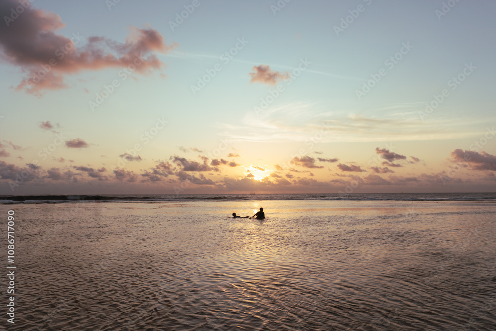 Fototapeta premium visitors are enjoying the sunset on the coast. enjoying a holiday on the beach