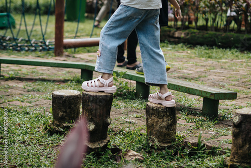 child's feet are walking on the playground footbridge, path of balance