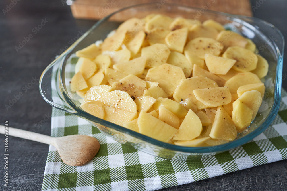 Homemade potato casserole in glass baking dish on wooden background Homemade potato casserole in glass baking dish on wooden background