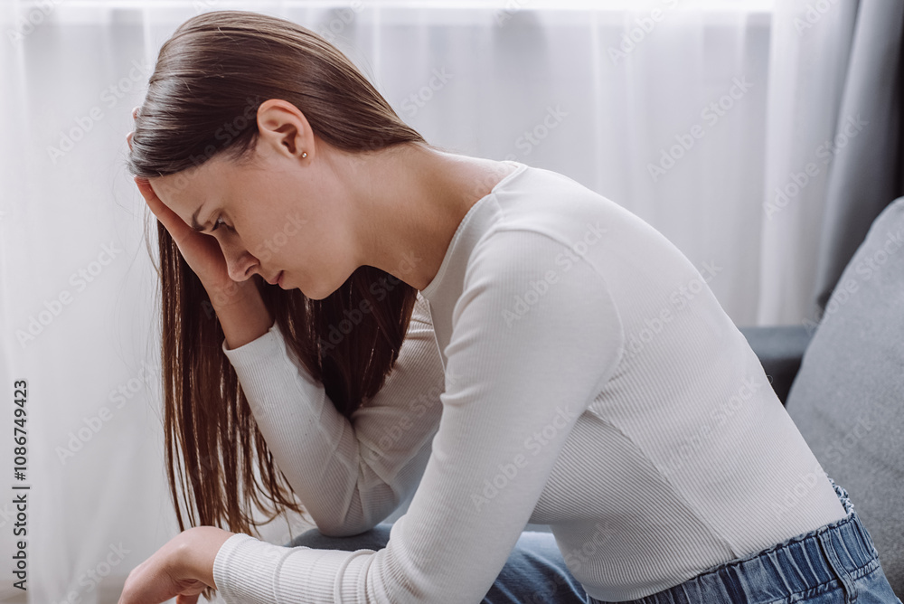 Frustrated young caucasian woman sit on couch at home alone, thinking about personal problem, break up with boyfriend or divorce, need psychological help, female feeling lonely and depressed concept Frustrated young caucasian woman sit on couch at home alone, thinking about personal problem, break up with boyfriend or divorce, need psychological help, female feeling lonely and depressed concept