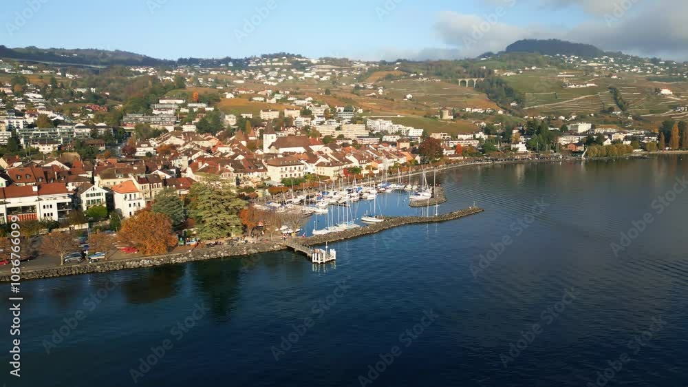 Orbit drone shot of Lutry Port with autumn colors in Canton of Vaud Switzerland Orbit drone shot of Lutry Port with autumn colors in Canton of Vaud Switzerland