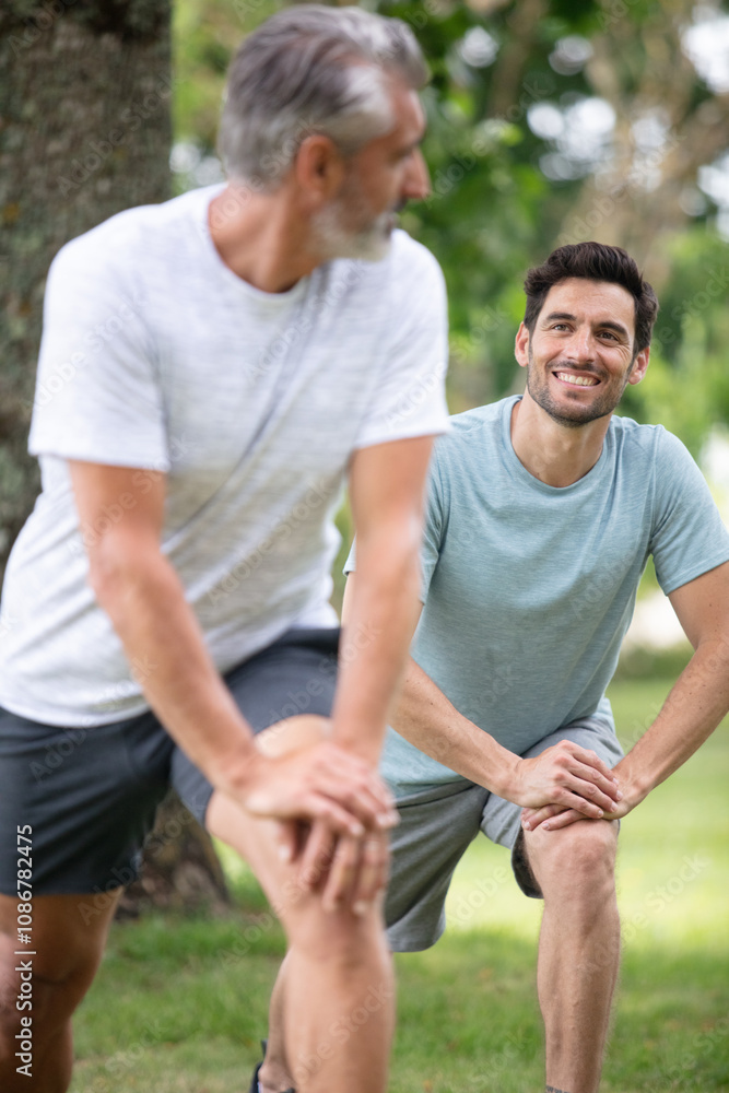 2 friends training together at the park 2 friends training together at the park