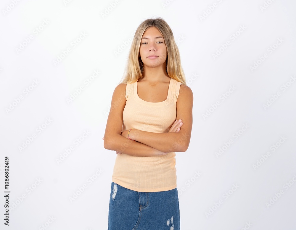 Serious pensive Beautiful teen girl wearing sleeveless t-shirt feel like cool confident entrepreneur cross hands. Serious pensive Beautiful teen girl wearing sleeveless t-shirt feel like cool confident entrepreneur cross hands.