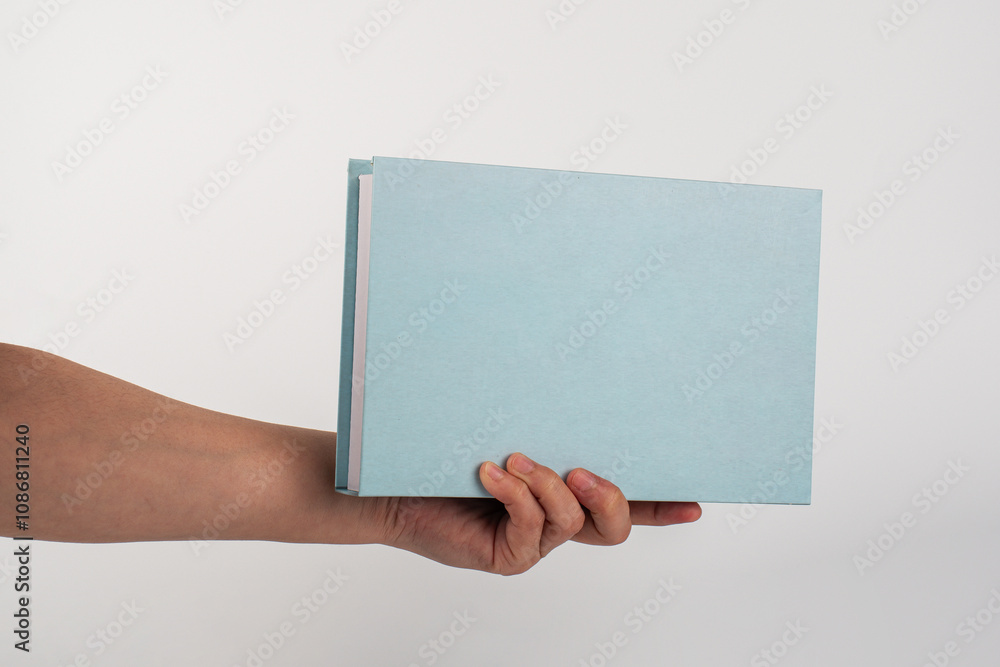 Blank book cover in hand on white background. Blank book cover in hand on white background.
