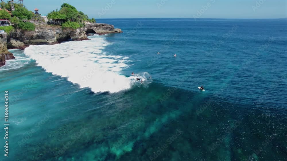 Drone aerial view of passionate water sports surfing in Bali, Indonesia Drone aerial view of passionate water sports surfing in Bali, Indonesia