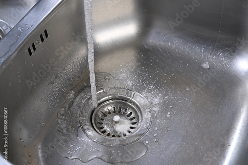 Lifehacks; Cleaning kitchen sink with baking soda to keep sinks draining well and prevent clogs     photo