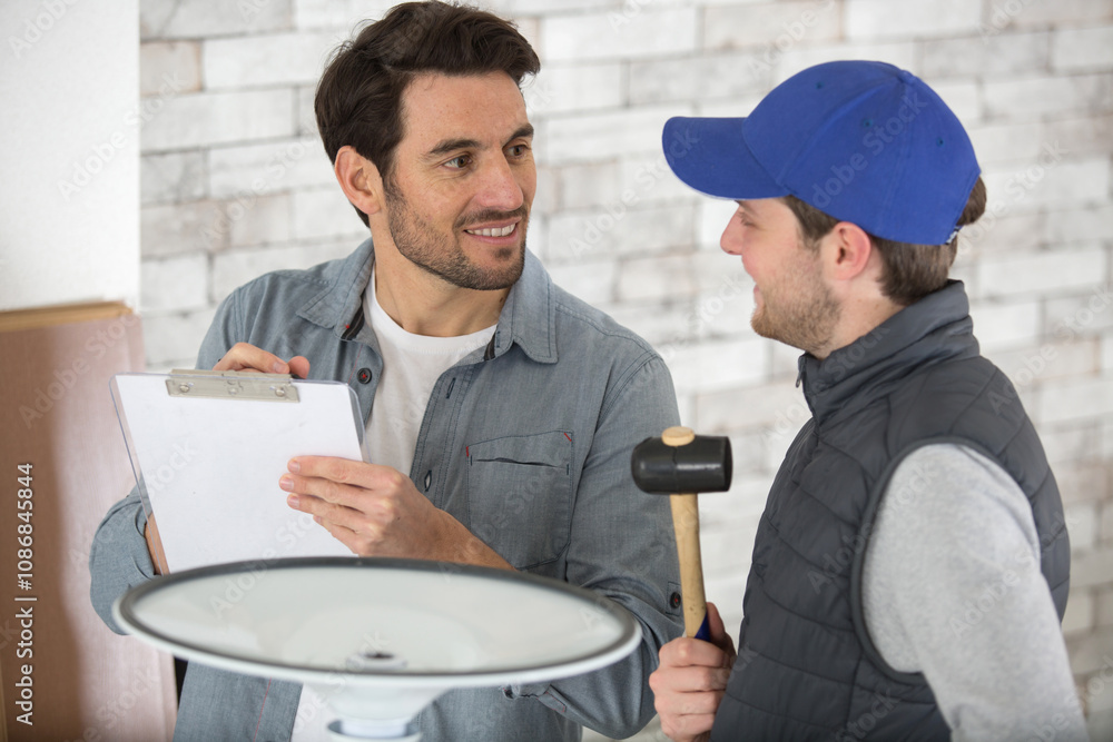 supervisor checking worker who has assembled a chair supervisor checking worker who has assembled a chair