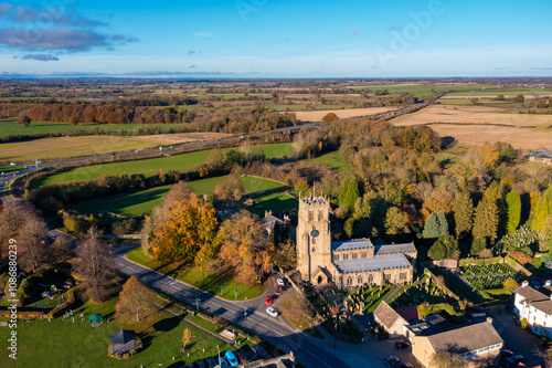 Aerial photo of the beautiful town of Bedale which is a market town in the Hambleton former district of North Yorkshire showing the beautiful town, church and motorway in the autumn time
