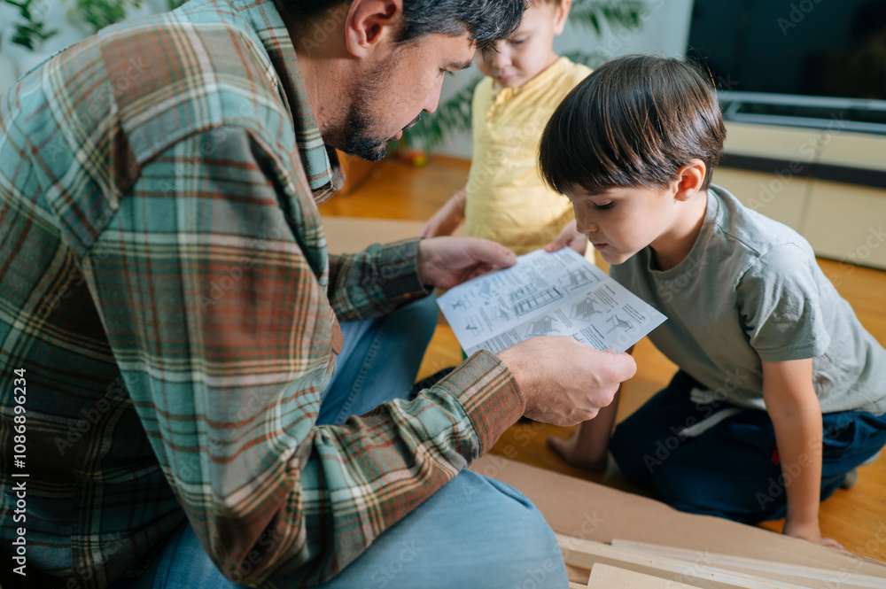 Father and son reading instruction manual at home
