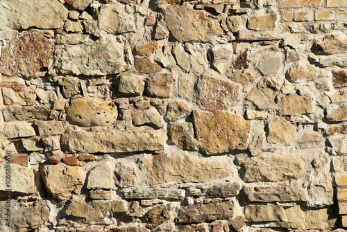 The photo shows a close-up of a stone wall