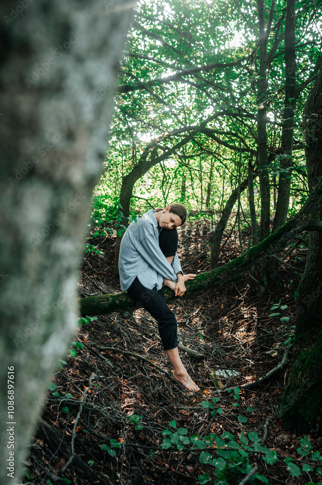 Mature woman sitting on tree trunk in forest Mature woman sitting on tree trunk in forest