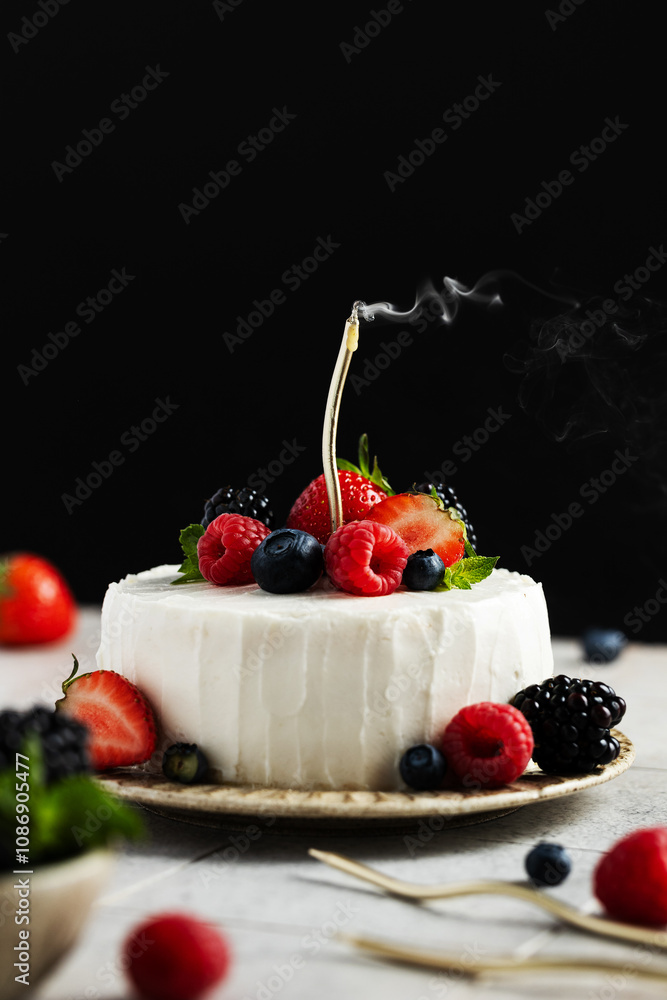 Small cake with cream cheese cream with a golden smoking candle. Bento cake decorated with fresh berries and frosting on a beige ceramic plate. Birthday dessert. Copy space Small cake with cream cheese cream with a golden smoking candle. Bento cake decorated with fresh berries and frosting on a beige ceramic plate. Birthday dessert. Copy space