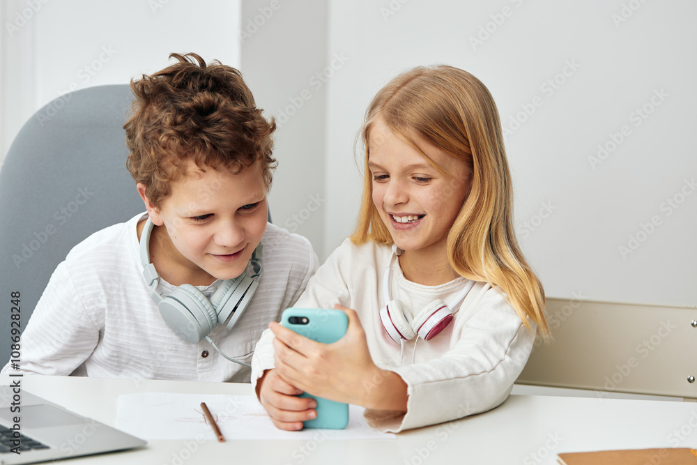 Happy Boy and Girl Learning Online with Laptops at Home Happy Boy and Girl Learning Online with Laptops at Home