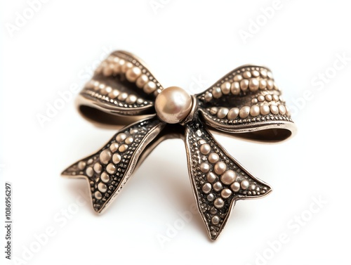 Elegant vintage bow brooch with pearl accents, white isolate background.