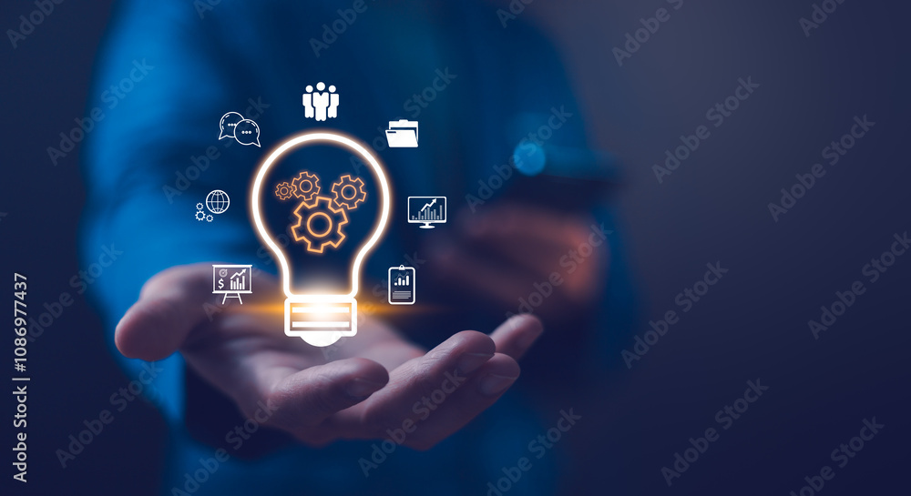 Concept of innovation and strategic thinking. Business solution idea glowing light bulb hovers above an outstretched hand, surrounded by icons of innovation and teamwork, symbolizing creative.