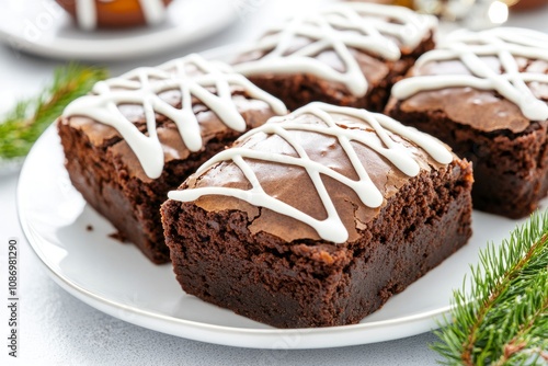 Chocolate brownies with white icing drizzles, served on a festive plate for a Super Bowl party.