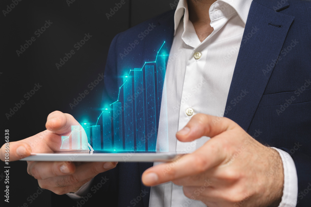 Businessman using tablet with financial graph and chart, stock market concept Businessman using tablet with financial graph and chart, stock market concept