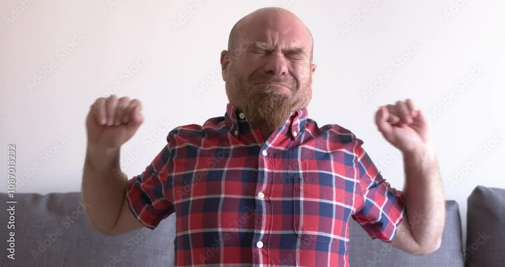 Bald Man Stretches Muscles After Long Time on Sofa Bald Man Stretches Muscles After Long Time on Sofa