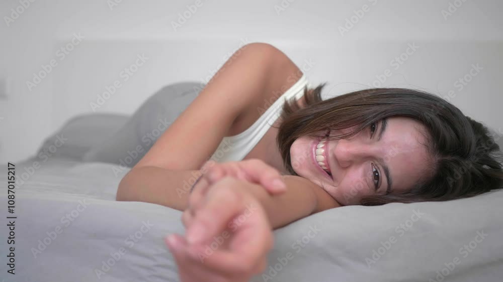 Girl lying on the bed, smiling at the camera, happiness, well-being,feeling good Girl lying on the bed, smiling at the camera, happiness, well-being,feeling good