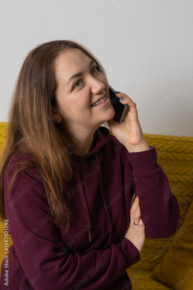 Woman wear braces using smartphone at home Woman wear braces using smartphone at home