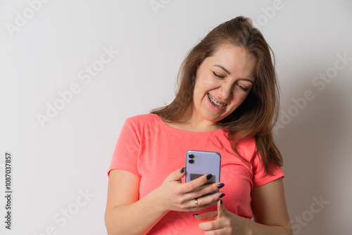 Woman wear braces using smartphone at home