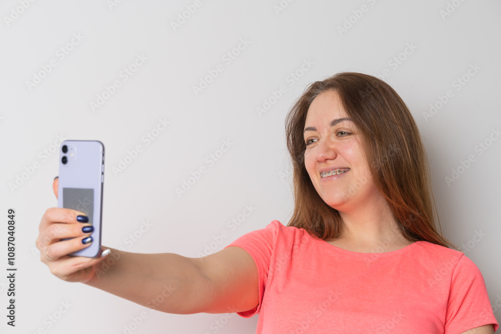 Woman wear braces using smartphone at home Woman wear braces using smartphone at home
