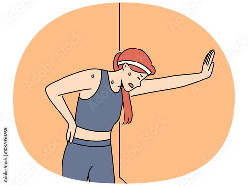 Tired woman runner with sweat on face, leaning against wall and trying to catch breath after long run. Young girl runner needs help of trainer due to excessive fatigue after workout.