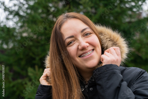 Woman portrait outdoors. Female smiling face with braces.