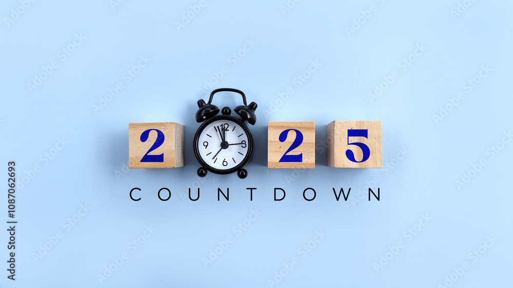 countdown 2025 text on wood block with black alarm clock on blue background. Countdown Happy new year concept countdown 2025 text on wood block with black alarm clock on blue background. Countdown Happy new year concept