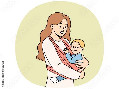 Mother holds baby in carrier sling and smiles, taking care of son and using comfortable babywearing. Caring happy woman with newborn, recommends purchasing sling for young mothers.