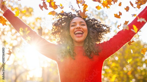 Obraz na płótnie Joyful woman in red sweater enjoying autumn sunlight and falling leaves in a golden seasonal forest
w salonie