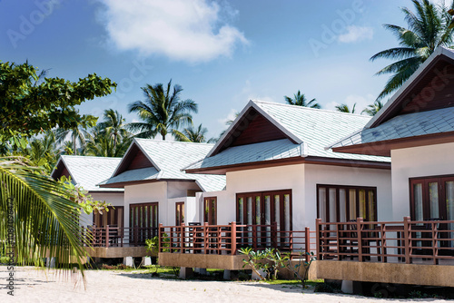 Fototapeta Naklejka Na Ścianę i Meble -  Tropical vacation. Resort. Small houses with balcony on the beach.