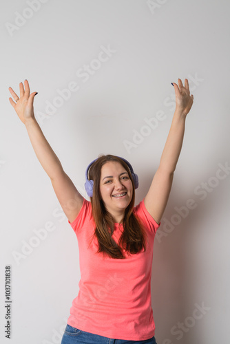 Modern woman smiling with braces on her teeth and listening to music