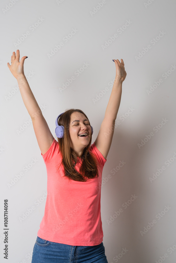 Modern woman smiling with braces on her teeth and listening to music Modern woman smiling with braces on her teeth and listening to music