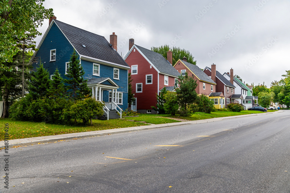 A view of colorful house in a residential street in Corner Brook in Newfoundland, Canada in the fall A view of colorful house in a residential street in Corner Brook in Newfoundland, Canada in the fall